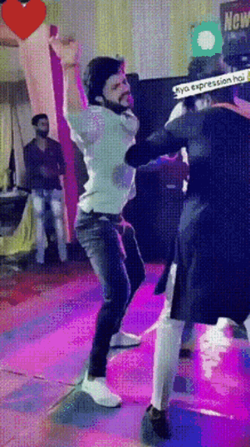 a man is dancing in front of a sign that says ' new ' on it