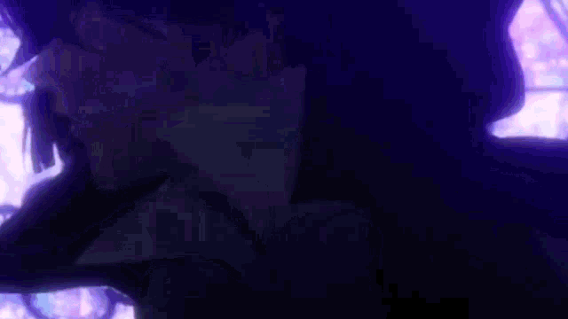 a close up of a person 's face in a dark room with a purple background .