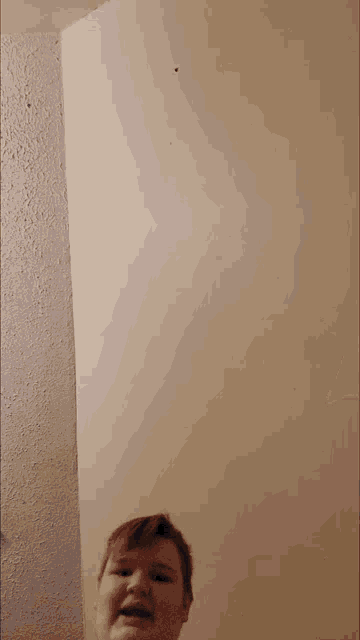 a person with their arms outstretched is standing in front of a wall