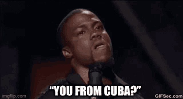 a man is talking into a microphone and saying `` you from cuba ? ''