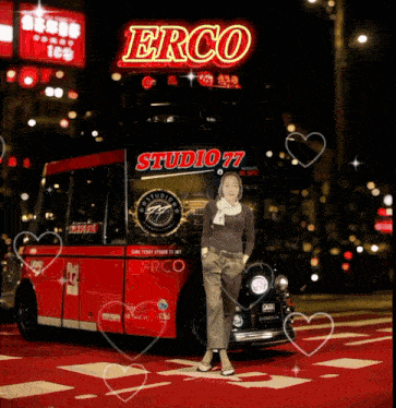 a woman is standing in front of a double decker bus that says studio 77