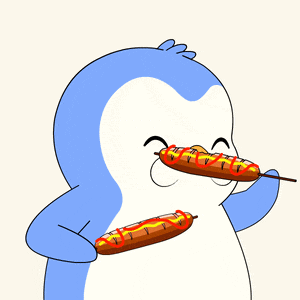 a blue and white penguin holding a hot dog with ketchup on it