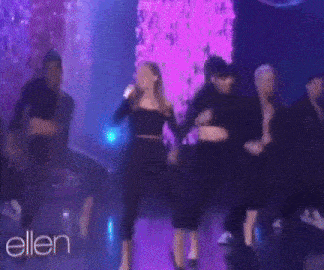 a group of women are dancing on a stage with the word ellen in the corner