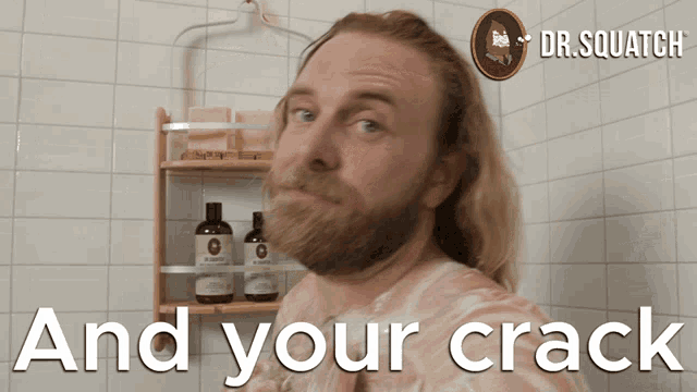 a man with a beard is standing in front of a shelf that says " and your crack " on it