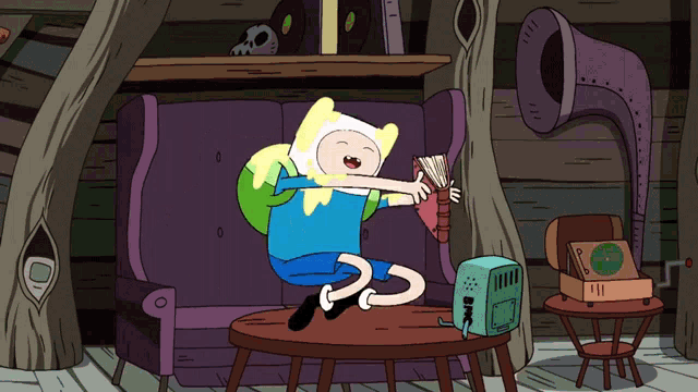 a cartoon character is sitting on a couch holding a book
