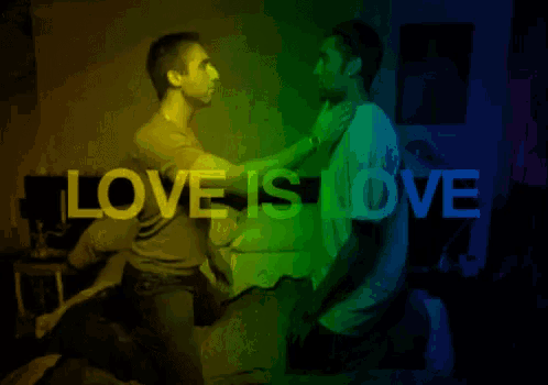 a woman kneeling next to a man with the words love is love in the background
