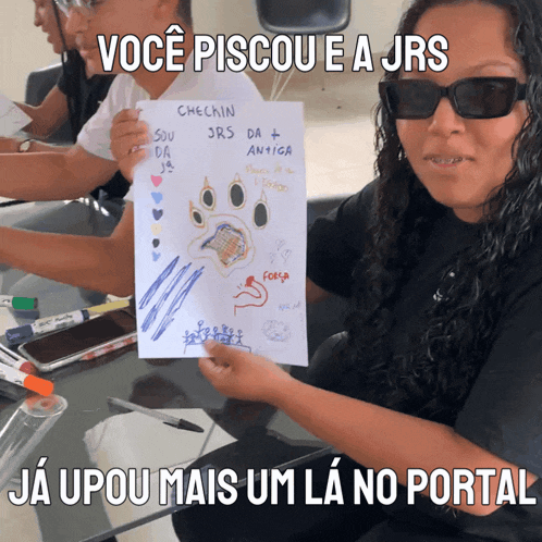 a woman holding up a piece of paper that says checkin jrs da + antiga