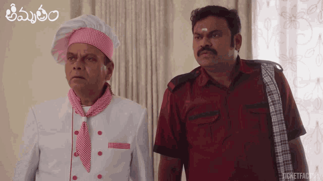 a man in a chef 's hat is standing next to another man