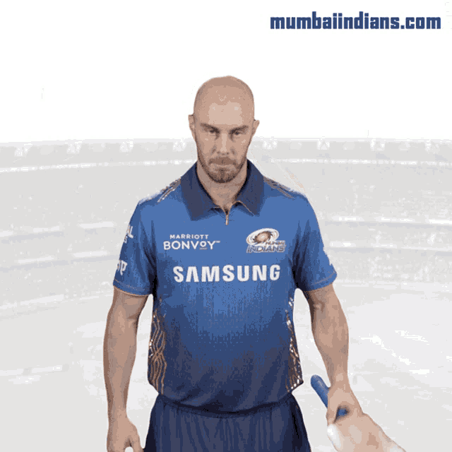 a man wearing a blue shirt with samsung on it