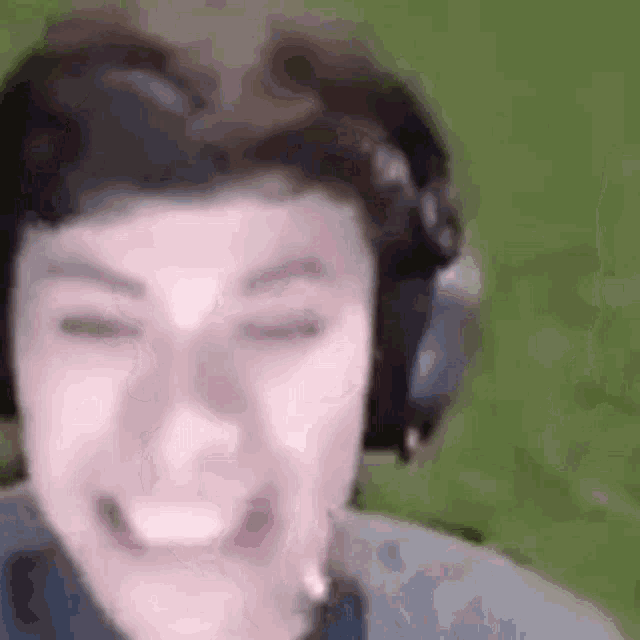 a close up of a person wearing headphones smiling .