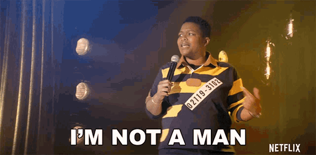 a man holding a microphone says " i 'm not a man " on stage