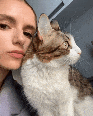 a close up of a woman and a cat
