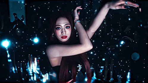 a woman with red hair is standing in a dark room