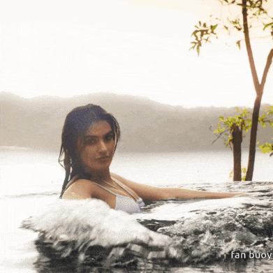 a woman in a bathing suit is swimming in a body of water with the words fan buoy on the bottom