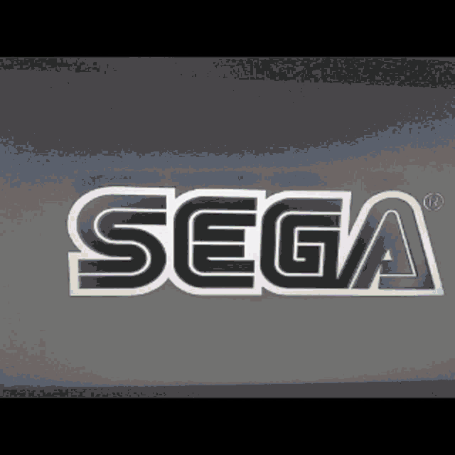 a close up of a sega logo on a gray background