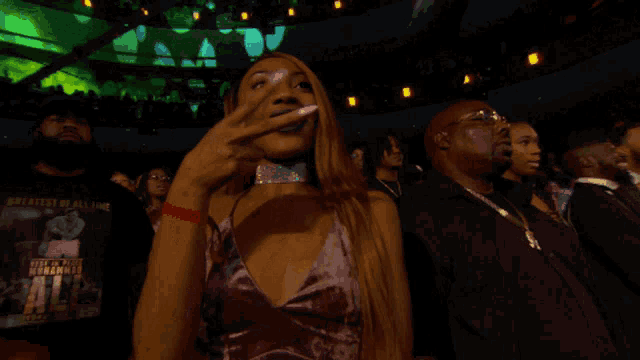 a woman wearing a choker and a t-shirt that says " best of all time "