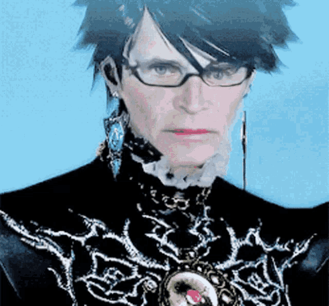 a man wearing glasses and a black and white outfit