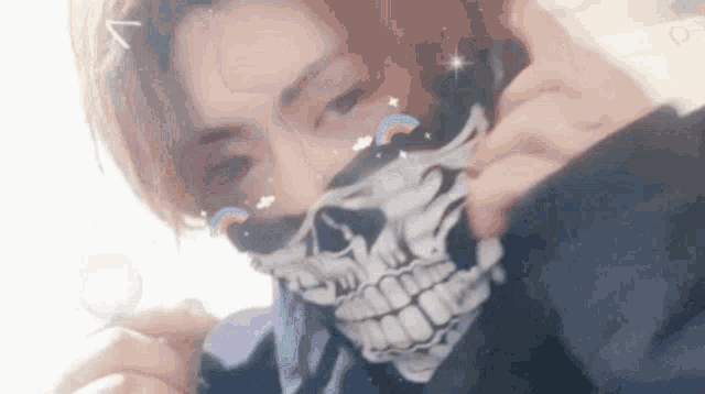 a close up of a person wearing a skull bandana around their neck .