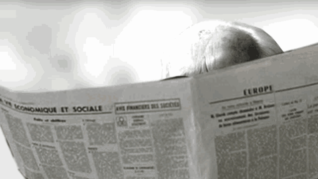 a person is reading a newspaper that says europe