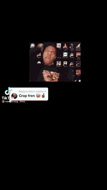 a man is standing in front of a computer screen with a reply to someone 's comment .