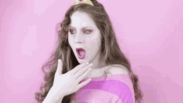 a woman is dressed as a princess and wearing a tiara on her head .