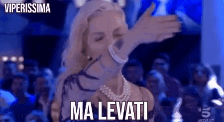 a woman is dancing in front of a crowd and the words ma levati are on the bottom of the image