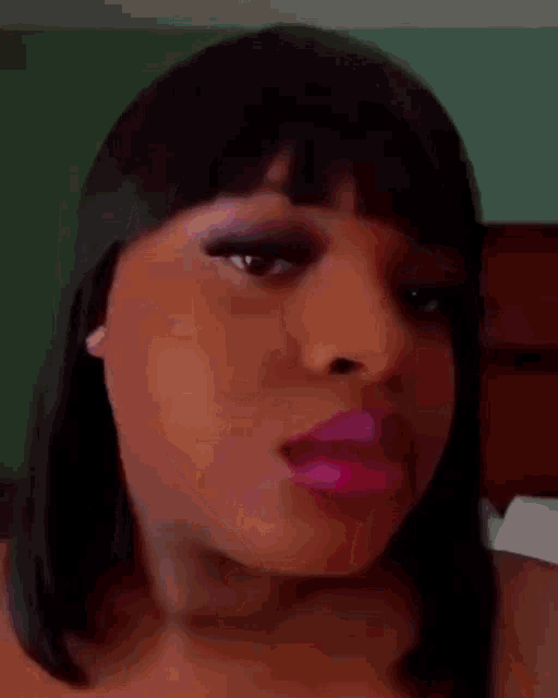 a close up of a woman 's face with pink lipstick on .