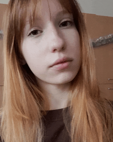 a close up of a girl 's face with long hair