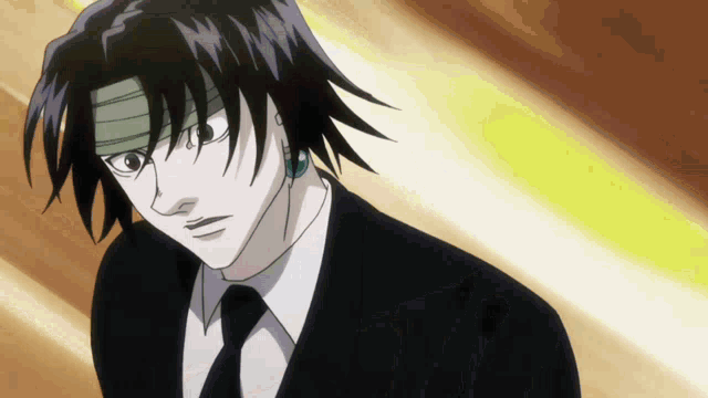 a man in a suit and tie is looking at the camera
