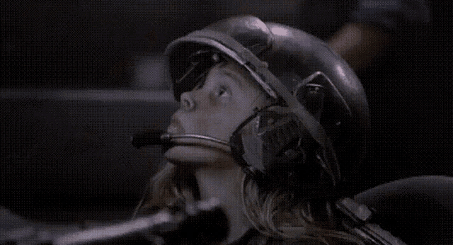 a woman wearing a helmet with a microphone on her head