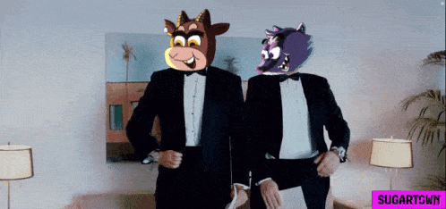 two men in tuxedos are standing next to each other with a purple sign that says sugartown on the bottom