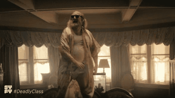 a man with a beard and sunglasses is dancing in a room with the hashtag #deadly class