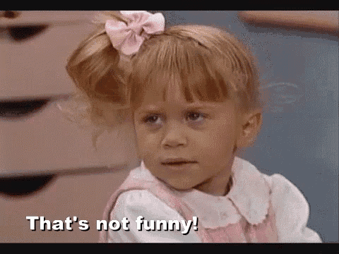 a little girl with a pink bow in her hair is making a funny face and saying `` that 's not funny '' .