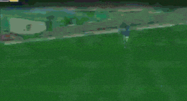 a soccer player is kicking a ball on a soccer field in a video game .