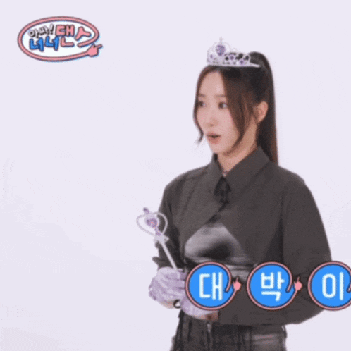 a woman wearing a tiara is surrounded by blue circles with chinese characters