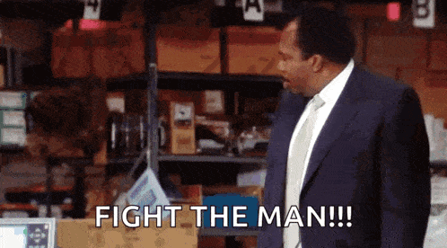 a man in a suit and tie says fight the man !!!