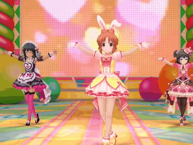 three anime girls are dancing on a stage and one has bunny ears on her head