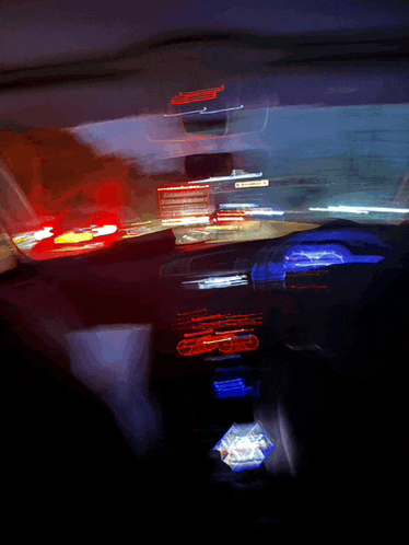 a blurry picture of the inside of a car with red and blue lights on
