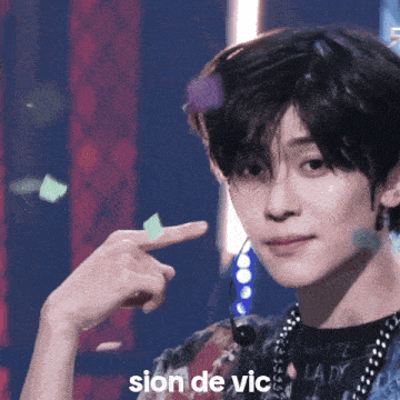 a close up of a person 's face with the word sion de vic written below it