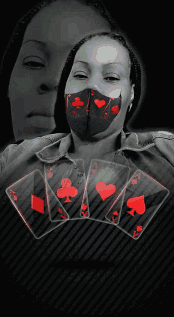 a woman wearing a face mask with playing cards on her face