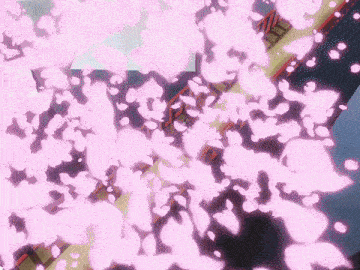 a person standing on a bridge with pink petals falling from the sky