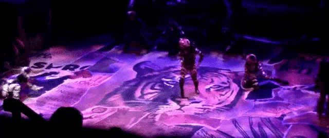 a group of people are dancing on a stage in front of a sign that says s.l.r.