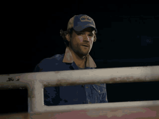 a man wearing a blue hat that says texas on it