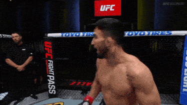 two men are fighting in a ring with a banner that says impossible on it