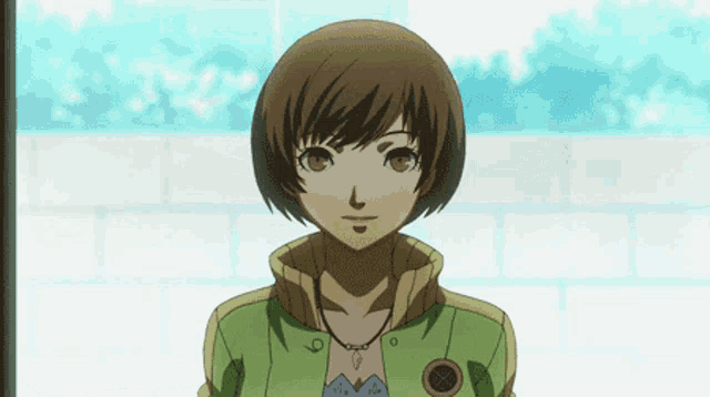 a girl with short brown hair is wearing a green jacket and a blue shirt .