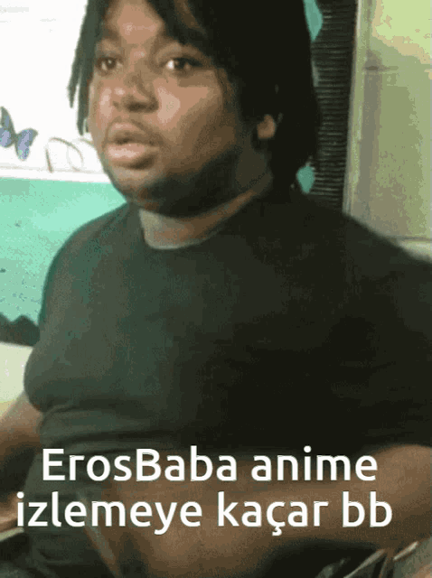 a man in a black shirt with the words erosbaba anime izlemeye kacar bb
