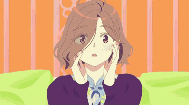 a girl with a scarf around her neck is sitting on a couch