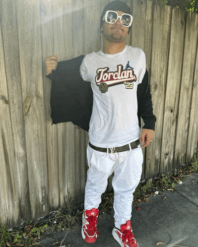 a man wearing a white jordan 23 shirt