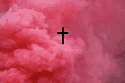 a cross is surrounded by pink clouds in the sky .