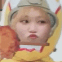 a close up of a person wearing a banana hat making a face .